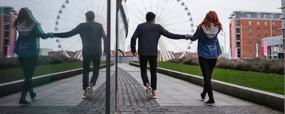 Two people walking toward a ferris wheel